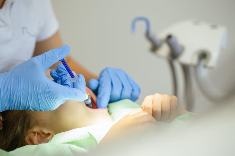 child-to-the-dentist-child-in-the-dental-chair-den-YMRCZWB