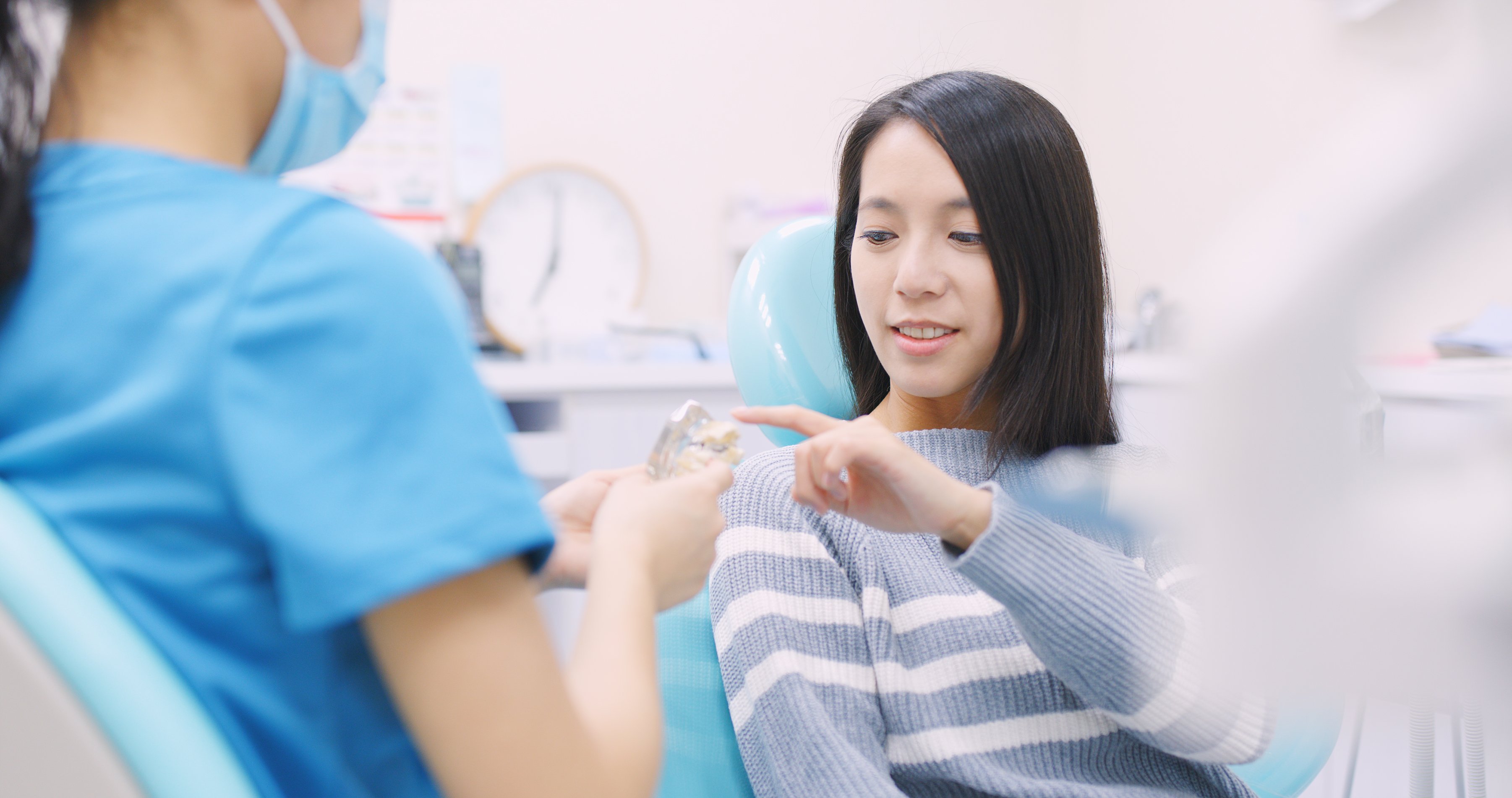 Doctor dentist explaining the implant of teeth to patient