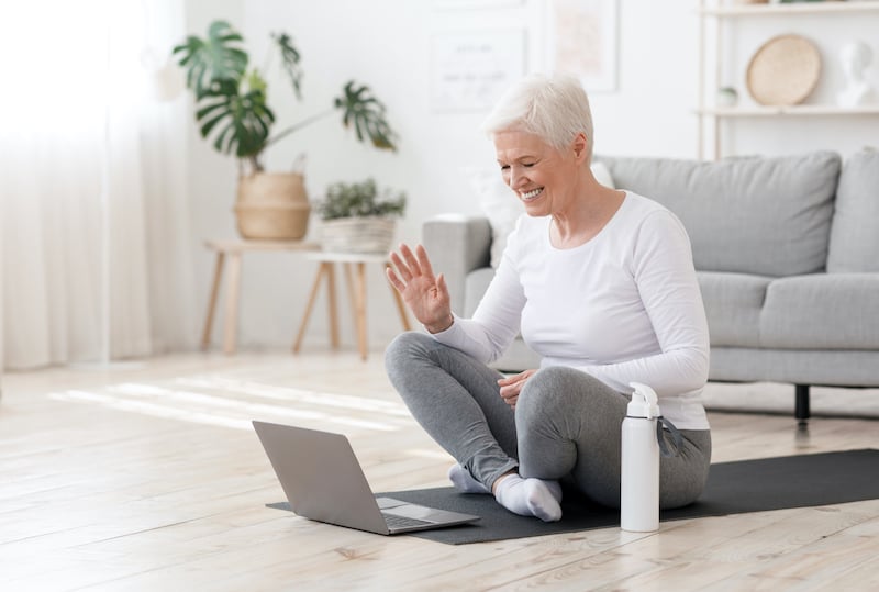 smiling-senior-woman-training-at-home-online-via-l-ZYQTR76